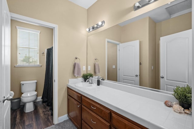 bathroom featuring vanity, toilet, and wood-type flooring