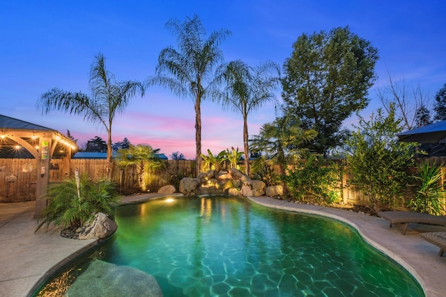 view of pool at dusk