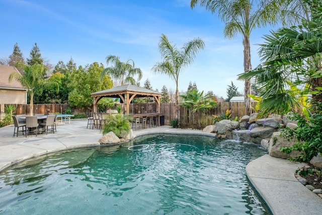 view of pool featuring a gazebo, a patio, exterior bar, and pool water feature