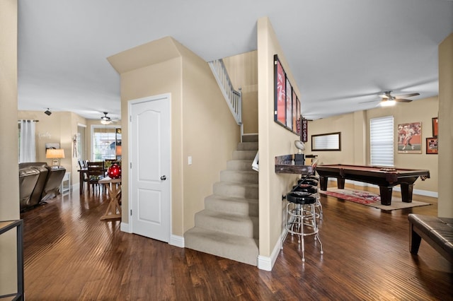 staircase featuring wood-type flooring, ceiling fan, and billiards