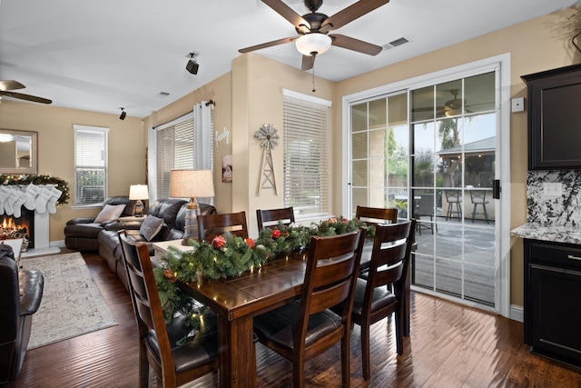 dining room featuring ceiling fan and dark wood-type flooring