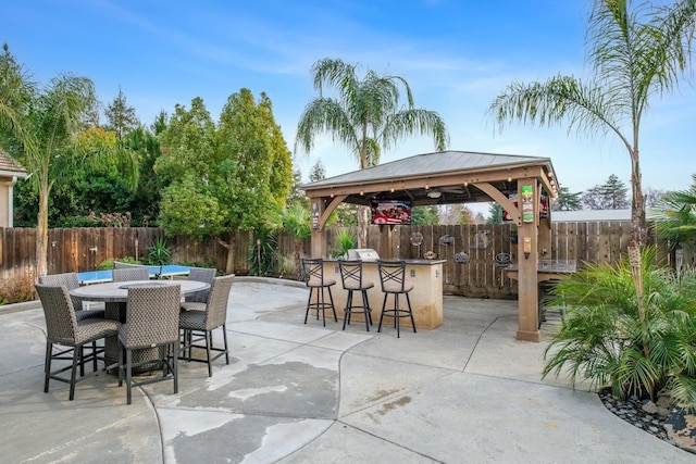 view of patio / terrace with a gazebo, grilling area, and a bar