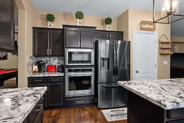 kitchen featuring hanging light fixtures, stainless steel appliances, tasteful backsplash, dark hardwood / wood-style flooring, and billiards