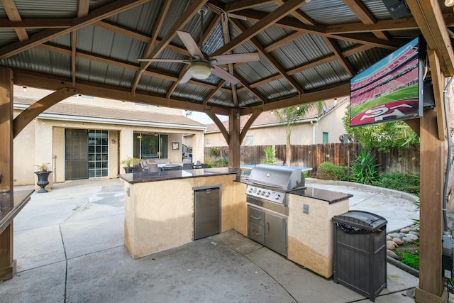 view of patio / terrace with a gazebo, area for grilling, ceiling fan, and an outdoor kitchen