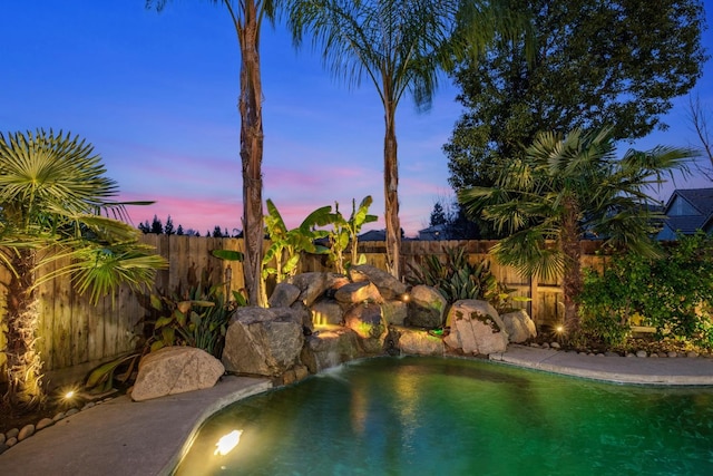 view of pool at dusk