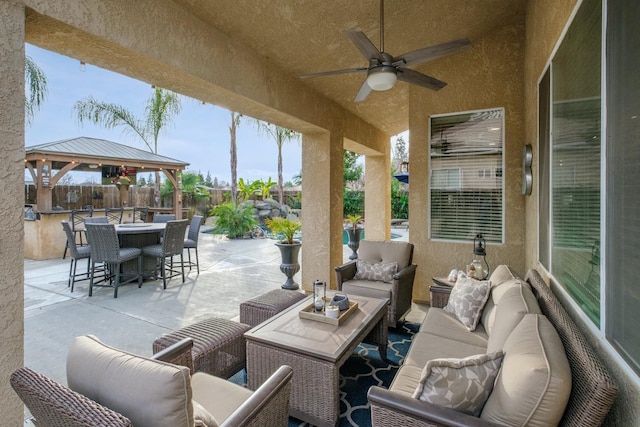 view of patio with a gazebo, ceiling fan, and outdoor lounge area