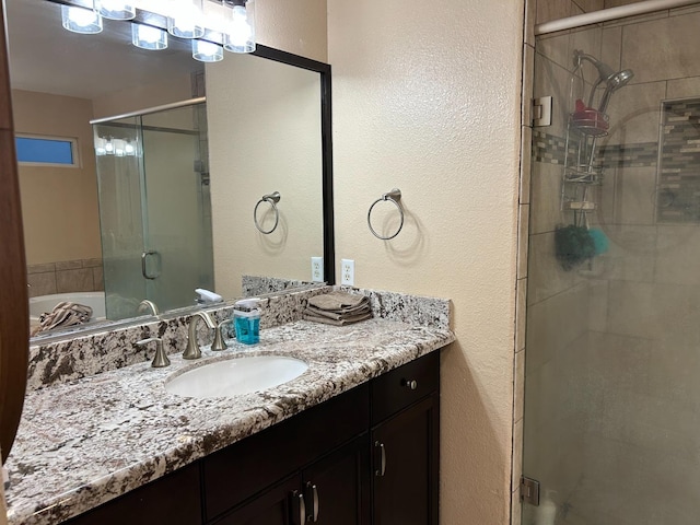 bathroom featuring vanity and independent shower and bath