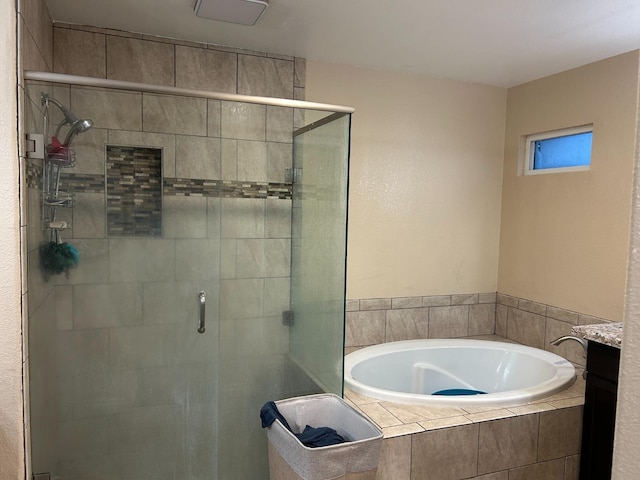 bathroom with vanity and independent shower and bath