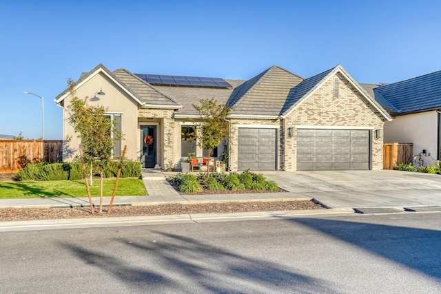 view of front of house with solar panels and a garage