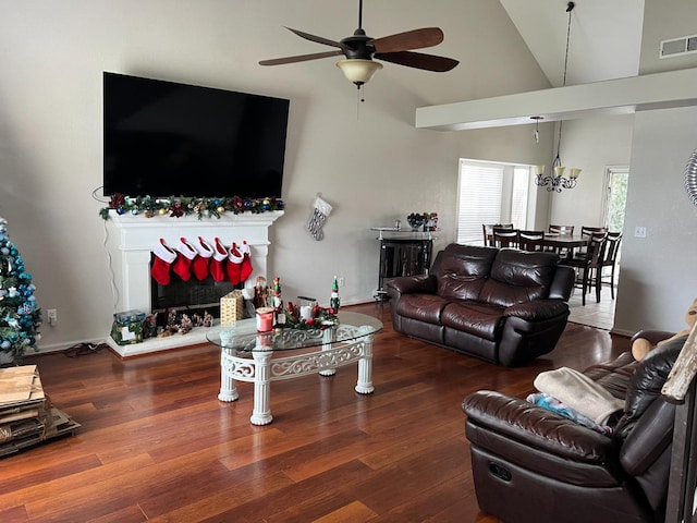 living room featuring high vaulted ceiling, dark wood-type flooring, and ceiling fan with notable chandelier