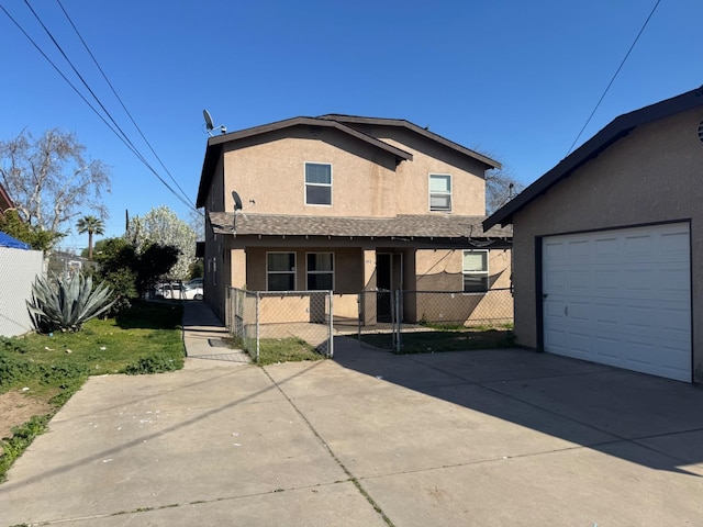 view of front of house with a garage, fence, driveway, and stucco siding