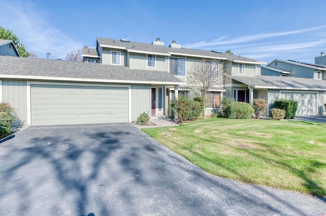 view of front of house with a garage and a front lawn