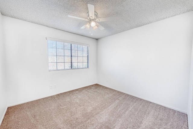 carpeted spare room with ceiling fan and a textured ceiling