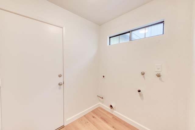 laundry room with hardwood / wood-style floors, hookup for a gas dryer, and electric dryer hookup