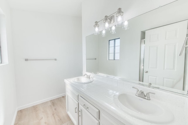 bathroom with hardwood / wood-style floors and vanity