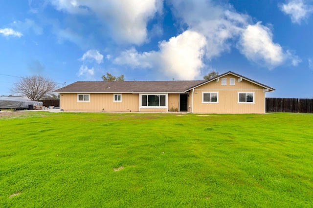 back of house featuring a yard