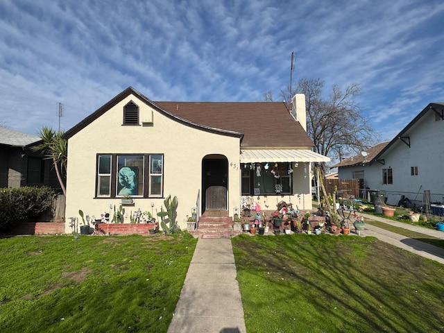 bungalow-style house with a front yard