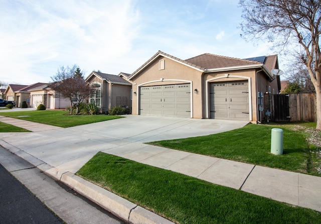 single story home with a garage and a front lawn