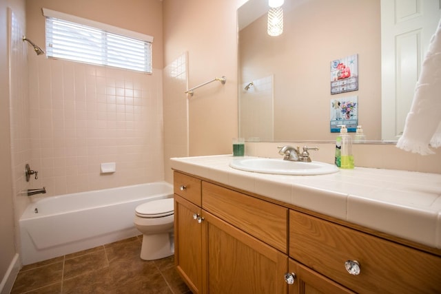 full bathroom with vanity, tiled shower / bath combo, toilet, and tile patterned flooring