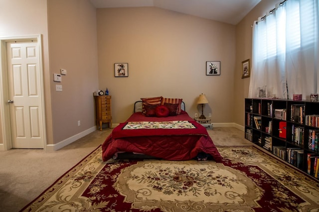 bedroom with light colored carpet and lofted ceiling