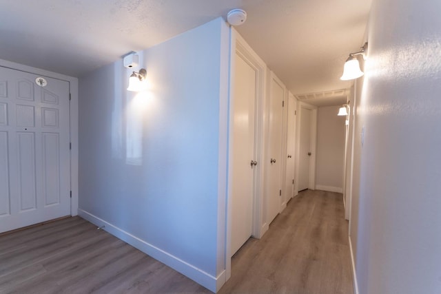 corridor with light hardwood / wood-style flooring