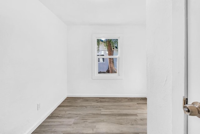 unfurnished room with light wood-type flooring