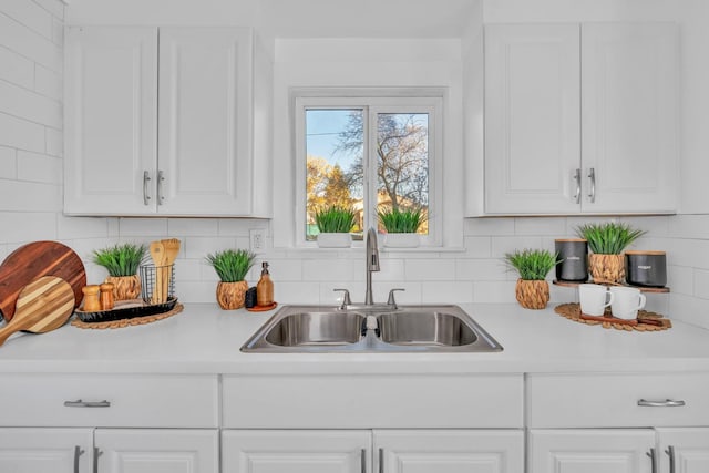 kitchen featuring white cabinetry and sink