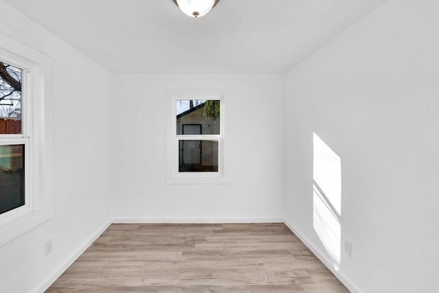 spare room featuring plenty of natural light and light hardwood / wood-style floors