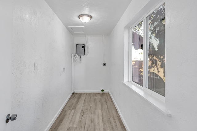 interior space with hookup for an electric dryer, plenty of natural light, and light wood-type flooring