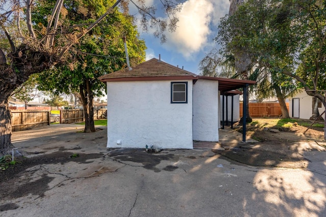 view of side of property featuring a storage unit