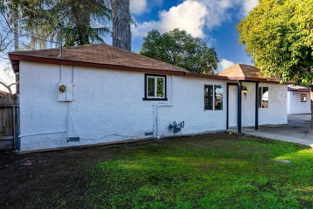 view of property exterior with a yard