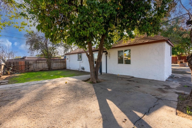 rear view of house with a lawn and a patio area