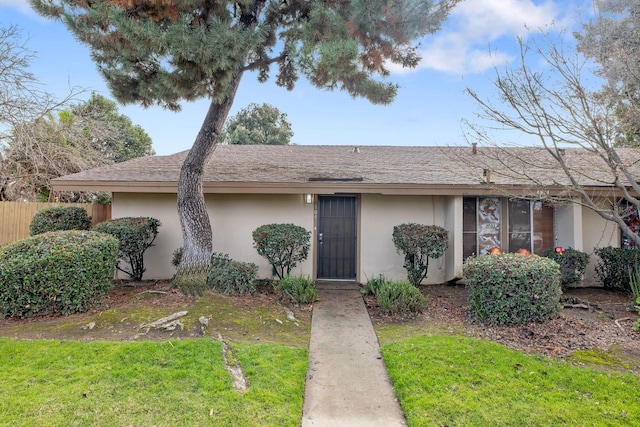 ranch-style home with a front lawn