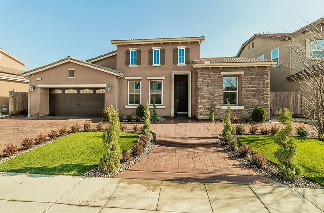 view of front of property featuring a front yard and a garage