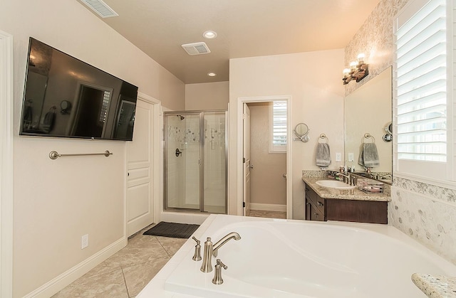 bathroom with tile patterned flooring, vanity, and shower with separate bathtub