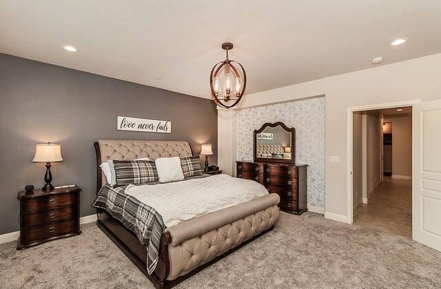 bedroom featuring light colored carpet and an inviting chandelier