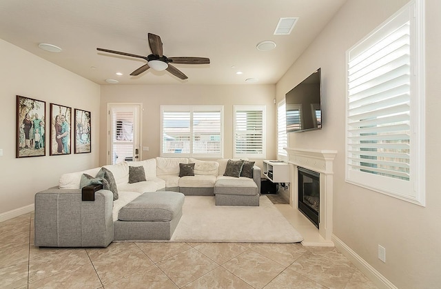 living room featuring ceiling fan and light tile patterned floors