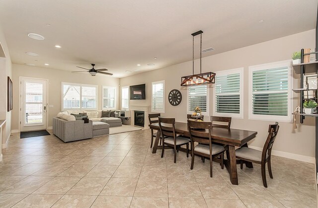 tiled dining area featuring ceiling fan