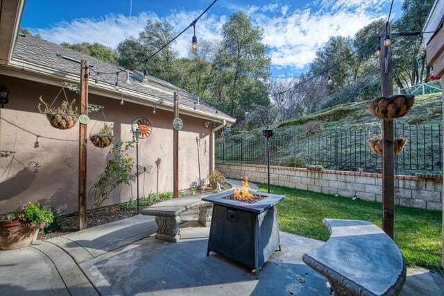 view of patio with an outdoor fire pit