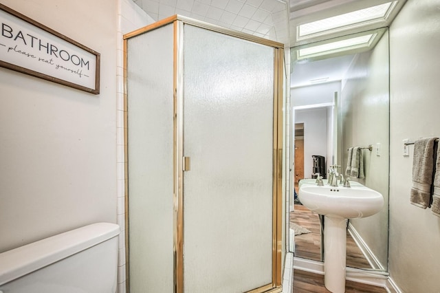 bathroom featuring toilet and an enclosed shower