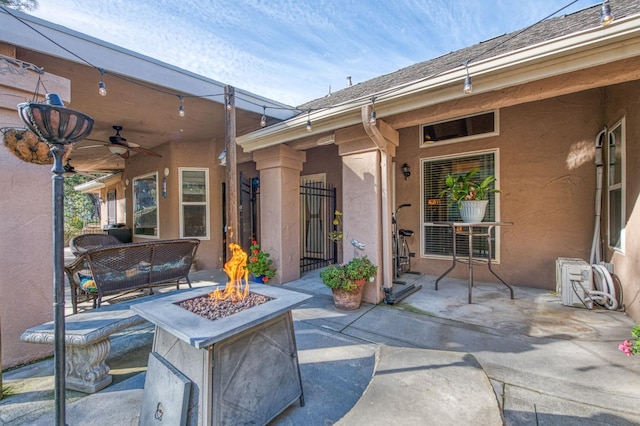 view of patio featuring a fire pit and ceiling fan