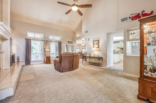 living room featuring light carpet, high vaulted ceiling, and ceiling fan