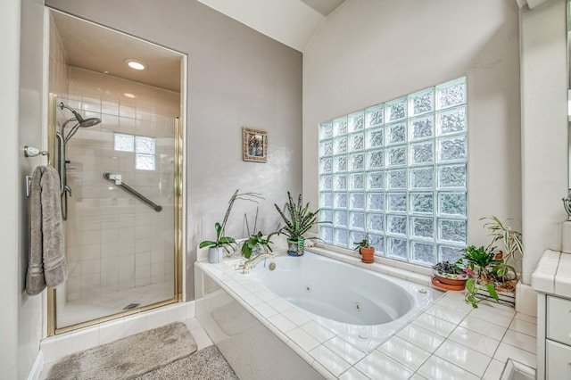 bathroom with shower with separate bathtub and tile patterned floors