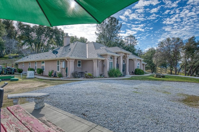 view of front of home featuring a front yard and central AC