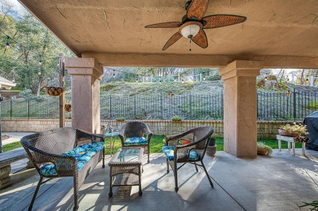 view of patio with an outdoor living space and ceiling fan