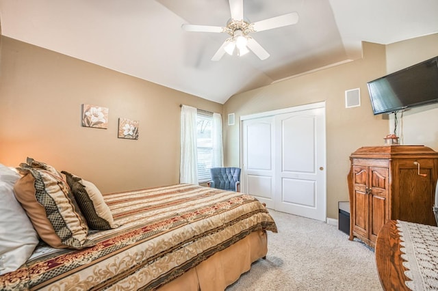 carpeted bedroom featuring ceiling fan, lofted ceiling, and a closet