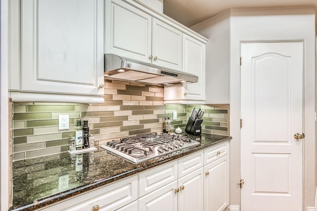 kitchen with white cabinets, backsplash, stainless steel gas cooktop, and dark stone countertops