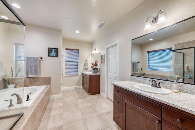 bathroom featuring plus walk in shower and vanity