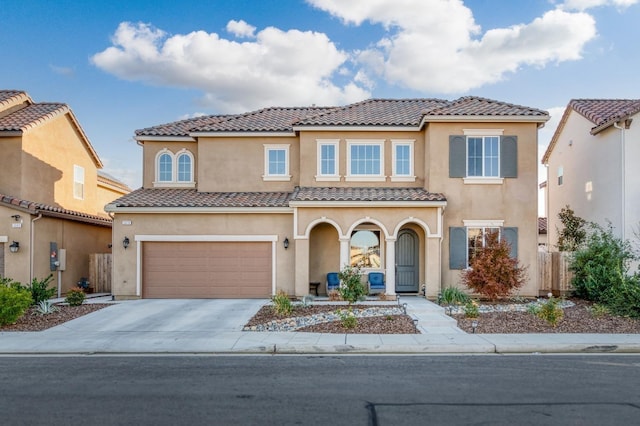 mediterranean / spanish-style home with a garage