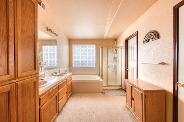 bathroom with vanity and independent shower and bath